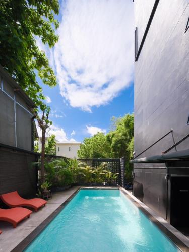 a swimming pool in the backyard of a house at 9.5Hotel Chiangmai in Chiang Mai