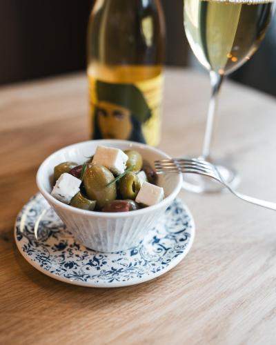 a bowl of food on a table with a glass of wine at MOLO LIPNO RESIDENCE in Lipno nad Vltavou