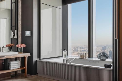 a bathroom with a tub and a large window at One&Only One Za'abeel in Dubai