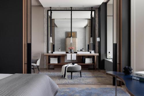 a bedroom with a bed and a bathroom with a sink at One&Only One Za'abeel in Dubai