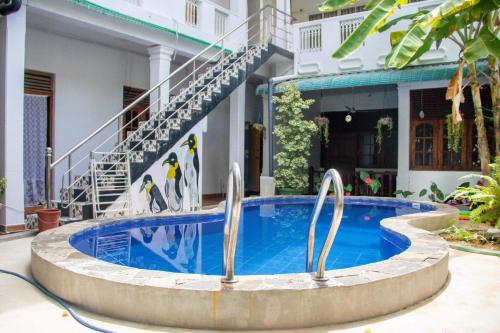 a swimming pool in front of a building at Yolanda Villa Negombo in Negombo