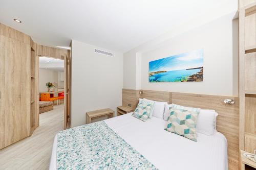 a white bedroom with a bed and a room at Leonardo Suites Hotel Mallorca Calvia in Torrenova