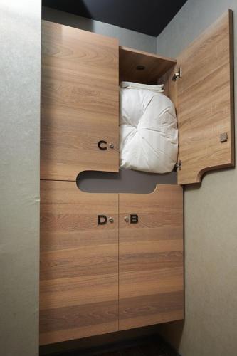 a wooden cabinet with a pillow on top of it at KIWI SHARE HOTEL ZHONGLI in Zhongli
