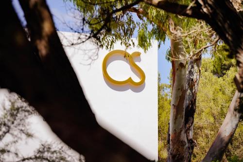 a sign with the google logo is seen through trees at Hotel Cala Saona & Spa in Cala Saona