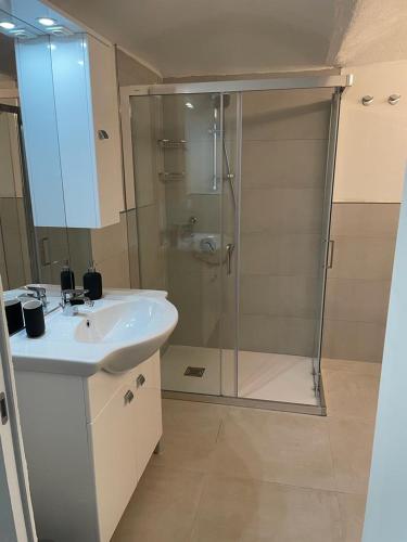 a bathroom with a glass shower and a sink at Loft Marconi 34 in Soverato Marina