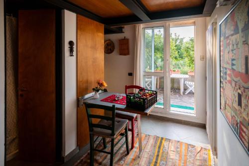 a room with a table and a chair and a window at Agriturismo Terre Bianche in Teolo