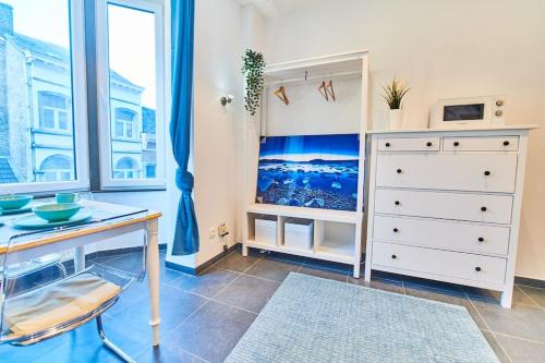 a room with a desk and a dresser and a window at Studio Hyper centre - Cathédrale in Liège