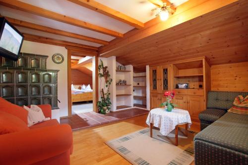 a living room with a couch and a table at Appartement Wurzrainer in Westendorf