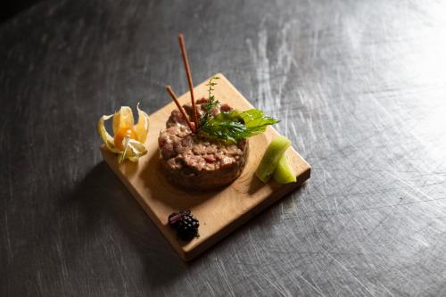 a plate of food on top of a table at Hotel Derby in Folgarida