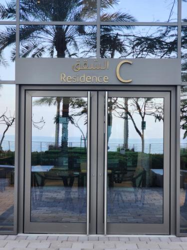 a glass door of a restaurant with a sign on it at Address Beach Resort Fujairah Apartment 2 Bed Rooms and Small Bed Room - Ground Floor 3011 in Al Aqah