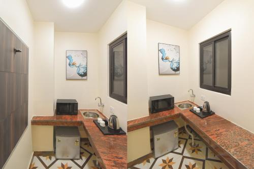a bathroom with two sinks in a room at Hotel Swagat Suites in Haridwār