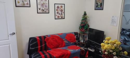 a living room with a couch and a christmas tree at Two-Bedroom at San Remo Oasis in Cebu City