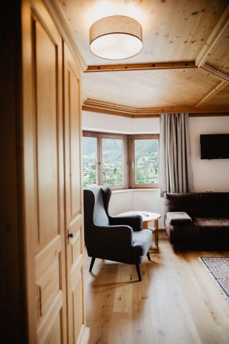 a living room with a chair and a couch at Ferienwohnungen Wartbichler in Lofer