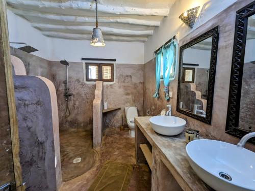 a bathroom with a sink and a mirror at Bahati Villa in Kiwengwa