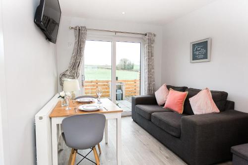 a living room with a couch and a table at Jack's Hideaway in Gatehouse of Fleet