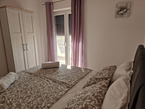 a room with a table and a window at Apartmani Natalija 4 Stars in Mrljane