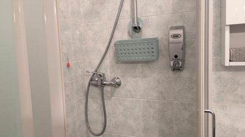 a shower in a bathroom with a phone on the wall at Casa Lilla in Verona