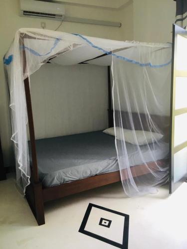 a bunk bed with a canopy in a room at Villa Twilight in Mirissa