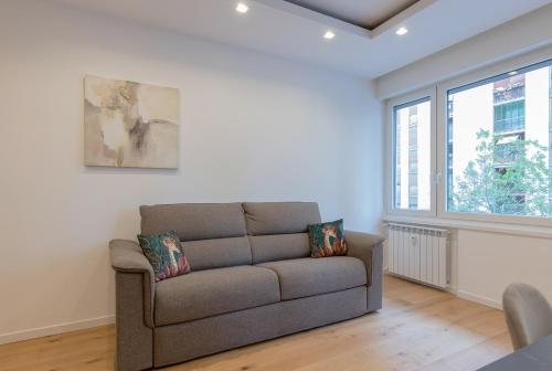 a living room with a couch and a window at Milan Retreats in Milan