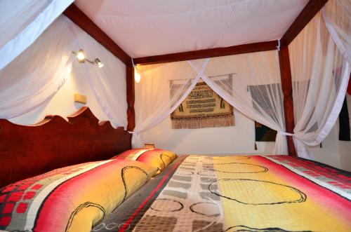 a room with two beds in a tent at Resort Svět in Úžice