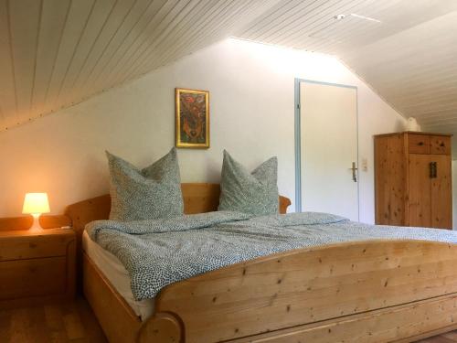 a bedroom with a wooden bed with blue pillows at Swiss View in Hohentengen