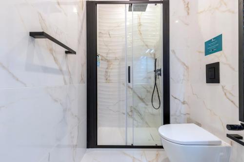 a bathroom with a shower with a toilet and a sink at Milan Retreats in Milan