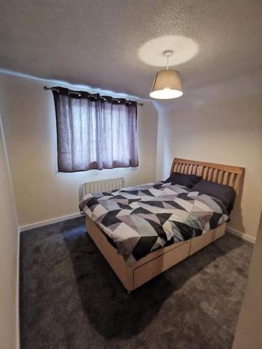 een slaapkamer met een bed en een raam bij Slateford Road Modern Apartment in Edinburgh