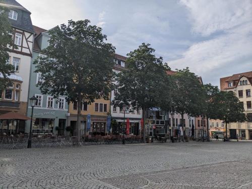 a street in a town with trees and buildings at Ferienwohnungen am Jenaer Markt, Mitten im Zentrum, für bis zu 5 und 6 Personen in Jena