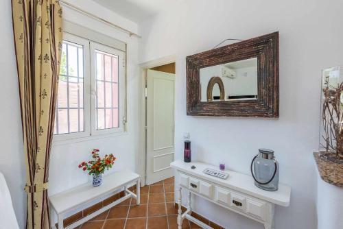 a bathroom with a mirror and a white sink at Casa Rural Villa Felisa in La Puebla de Cazalla
