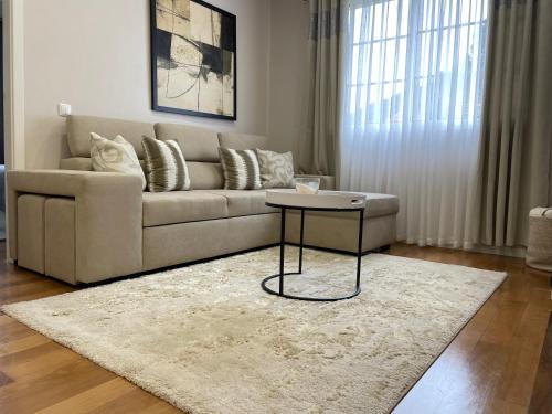 a living room with a couch and a table at Casa da Grota in Porto Moniz