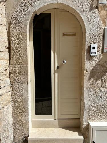 a front door of a house with an archway at SUITE 1 in Palo del Colle