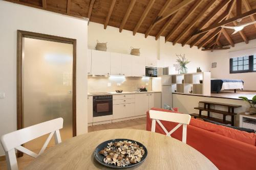 a kitchen and living room with a table and a couch at Las Tres Palmeras in Güimar