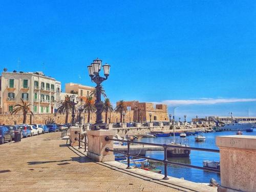 a bridge over a river with buildings and a harbor at Mediterranean House in Bari