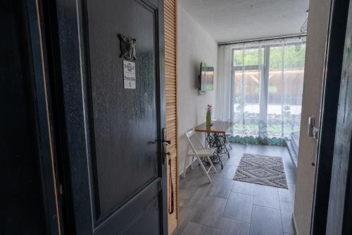 a door leading to a room with a table and a window at Bârlogul Vikingilor in Şotrile