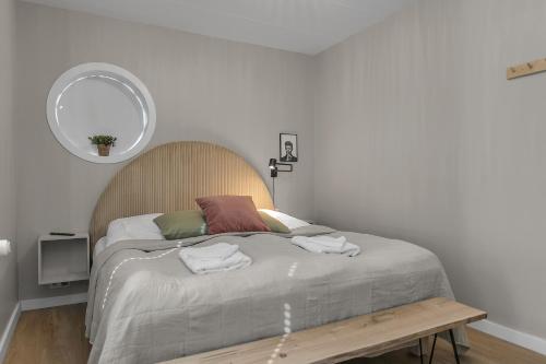 a bedroom with a bed with a table and a mirror at Two bedroom downtown apartment with balcony in Akureyri