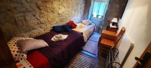 a bedroom with two beds and a wall at Casa de Férias V6 com piscina in Ponte de Lima