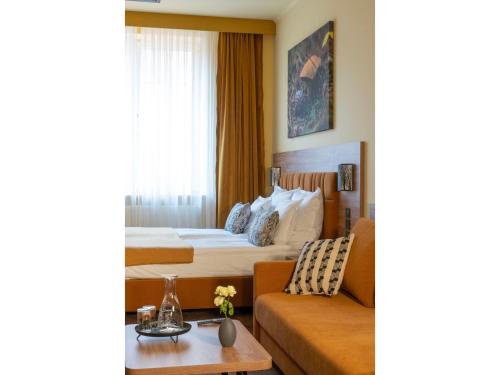 una camera d'albergo con letto e divano di MARIENSZTAT 8 Apartments a Varsavia