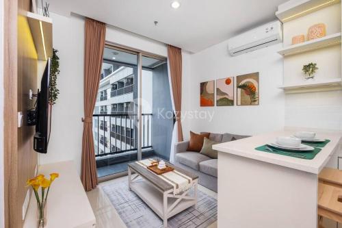 a living room with a couch and a table at Yukari by Kozystay 1BR Near MRT Sudirman in Jakarta