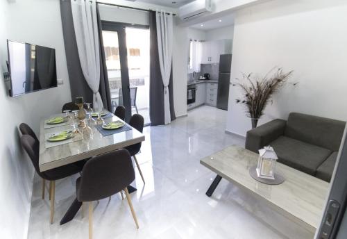 a dining room and living room with a table and a couch at Nick and Helen in Rethymno Town