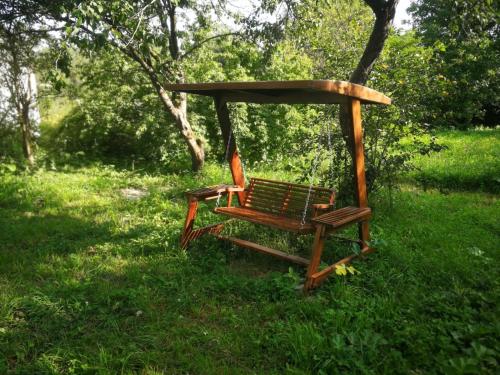 a swing sitting in the grass in a park at White house Dsegh in Dsegh