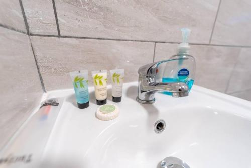 a bathroom sink with toothbrushes and a faucet at Stunning 1-Bed Studio in Birmingham available in Birmingham
