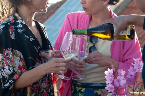 two women are holding glasses of wine at Cheese & Wine Lapa in Lisbon