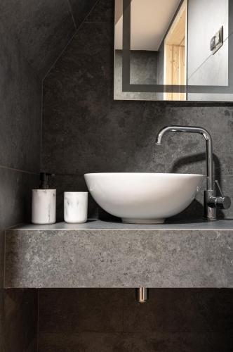 a bathroom with a white sink and a mirror at Dom Tatrzański Ewa II in Kościelisko