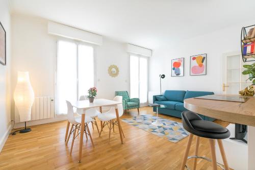 a living room with a blue couch and a table at 56-chabot-charny in Dijon