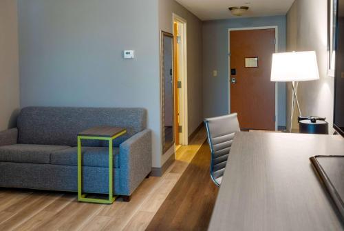a living room with a couch and a table at La Quinta by Wyndham Edmond in Edmond