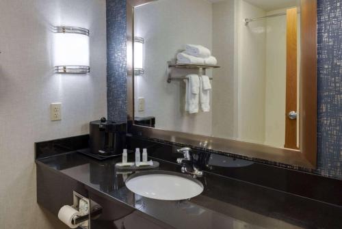 a bathroom with a sink and a mirror at La Quinta by Wyndham Edmond in Edmond