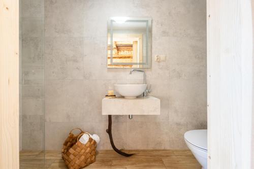 a bathroom with a sink and a mirror on the wall at Dom Tatrzański Ewa II in Kościelisko