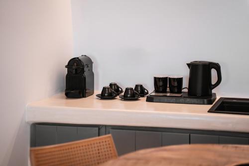 a counter with a coffee pot and boots on it at Bligos Villas in Oia