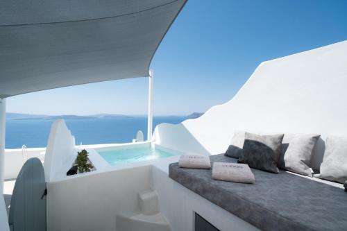 a white room with a swimming pool on a yacht at Bligos Villas in Oia
