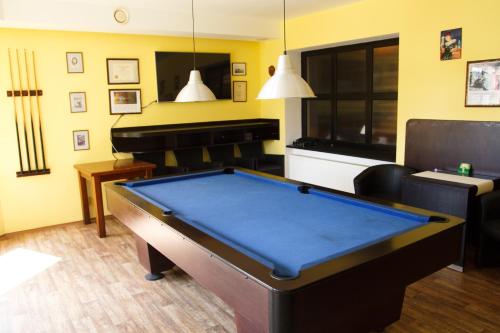 a living room with a pool table and a piano at Restaurace-Penzion U Pilota in Kněževes